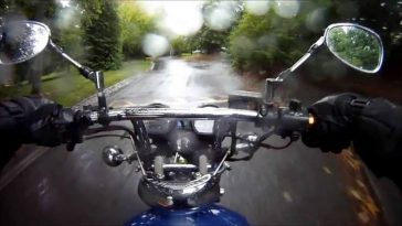 A Motorcycle rider riding his bike in rain