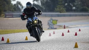 A bike rider testing motorbike on a racing track