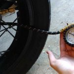 A peron checking air quantity in bike tyre