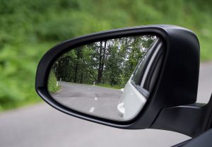 A picture of Car's side mirror view of road